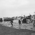 D-DAY - BRITISH FORCES DURING THE INVASION OF NORMANDY 6 JUNE 1944 (B 5246) Commandos of 47 (RM) Commando coming ashore from LCAs (Landing Craft Assault) on Jig Green beach, Gold area, 6 June 1944. LCTs can be seen in the background unloading priority vehicles for 231st Brigade, 50th Division. Copyright: © IWM. Original Source: http://www.iwm.org.uk/collections/item/object/205193123